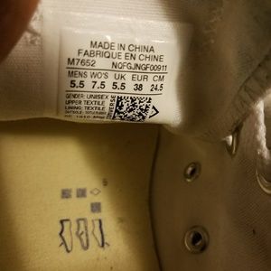 A pair of white converse tennis shoes